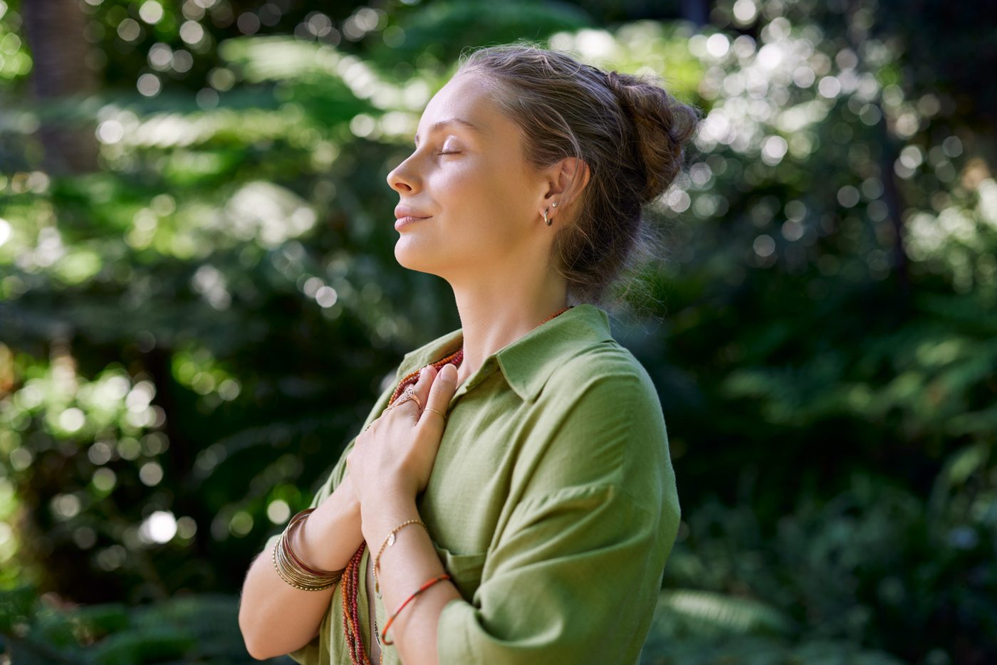 A woman with her hand on her chest, calm and reassured